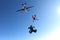 Formation skydiving. A group of skydivers is in the winter season.