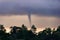 Formation of a tornado on sea in tropics against background of jungle
