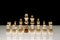 Formation of white chess pieces with a black pawn