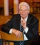 Former Federal President Joachim Gauck sits sideways on a chair while talking