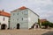 Former meat shops, colorful houses, sunny day, renaissance and baroque historical buildings, sundial on facade, information center