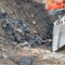 Former rubbish dump in the excavation pit, black discoloured and