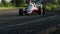 Formula 1 car driving desert circuit, taking fast turn