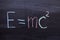 A formula from physics on a chalkboard. E equals MC square