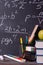 Formulas, chalk inscriptions on a  school blackboard, books, pens,  apples, markers