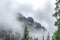 Forrest with mountains covered in low clouds. High Tatra mountains, NiÅ¾nÃ½ Å½abÃ­ Å¡tÃ­t, Slovakia