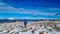 Forstalpe - Man with hiking backpack walking on snow covered alpine meadow on trail from Ladinger Spitz