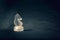 Forsted white glass knight chess piece on dramatic background