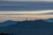 Forstsee - Panoramic scenic view of the viewing tower Pyramidenkogel and the snow capped Karawanks