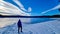 Forstsee - Rear view of man with hiking backpack watching the frozen lake Forstsee, Techelsberg, Carinthia (Kaernten), Austria,