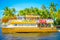 FORT LAUDERDALE, USA - JULY 11, 2017: Colorful yellow water taxi with a gorgeous view of river walk promenade highrise