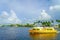 FORT LAUDERDALE, USA - JULY 11, 2017: Colorful yellow water taxi with a gorgeous view of river walk promenade highrise