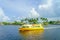 FORT LAUDERDALE, USA - JULY 11, 2017: Colorful yellow water taxi with a gorgeous view of river walk promenade highrise