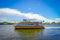 FORT LAUDERDALE, USA - JULY 11, 2017: Colorful yellow water taxi with a gorgeous view of river walk promenade highrise