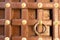 Fortified wooden gate with brass inserts and a knocker ring at udaipur palace india