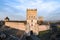 the fortress is made of brick and stone, with a clock tower