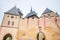 Fortress wall with aged clock of medieval castle Karlstejn