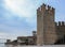 Fortress wall with a corner tower and promenade in front of the Scaliger Castle