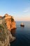 Fortress walls of Dubrovnik with a pirate galleon ship sailing in the harbor at sunset