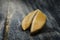 Fortune Cookie on wooden table with a piece of hope paper inside