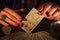 Fortune teller hands showing The moon tarot card. Close-up with candle light, moody atmosphere