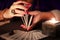 Fortune teller hands shuffling tarot cards. Close-up, moody atmosphere