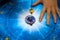 Fortune teller with magic pendulum on blue horoscope like astrology, zodiac. esoteric topic