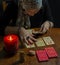 A fortune teller reads the tarot cards to predict the future