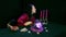 A fortuneteller in a magic salon blows out candles after a session on a black background