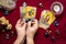 Fortuneteller`s hand with black manicure lays out tarot cards, crystal, candle, dry roses on red tablecloth