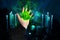 Fortuneteller`s hand explains the meaning of magical stone for fortune-telling for future, in dark room candles are burning in