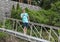 Forty-four year-old Caucasian male standing on the footbridge from shore to boat dock on Grand Lake in the state of Oklahoma.