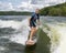 Forty-four year-old Caucasian male wake surfing at Grand Lake in Oklahoma.