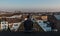 Forty year old man sitting on the roof overlooking the Brussels skyline during sunset