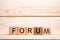 Forum word concept. The word Forum on wooden cubes. Forum as steps to progress our business. Forum to control our health