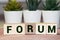 Forum word made of wood background