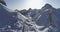 Forward aerial along road above snowy valley at Valparola pass.Sunny sunset or sunrise, clear sky.Winter Dolomites