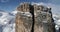 Forward aerial toward majestic Cinque Torri mounts showing steep rocky cliff. Sunny day with cloudy sky.Winter Dolomites