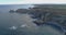 Forward movement in an general aerial view near sea getting closer to the coastline with a lot of cliffs