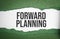 forward planning words on green torn paper