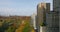 Forwards ascending fly along buildings surrounding park. Beautiful autumn colour trees in Central park. Manhattan, New