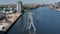 Forwards descending fly towards Molecule Man near bank of Spree river. Sculpture of three human silhouettes from