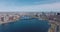 Forwards fly above deep blue surface of Charles river at Longfellow Bridge. Aerial panoramic view of metropolis. Boston