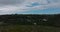 Forwards fly above green meadow. Revealing family houses between trees. Port Elisabeth, South Africa