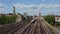 Forwards fly above multi track railway Grosvenor Bridge across Thames river. Tracking of train heading to Victoria