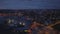 Forwards fly above shipyards at dusk. Aerial panoramic evening view of cityscape under cloudy sky. Helsinki, Finland