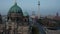 Forwards fly around Berlin cathedral in twilight time. Tall TV lookout tower, Fernsehturm, in background. Berlin