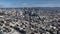 Forwards fly high above city. Aerial panoramic view of metropolis with downtown skyscrapers.