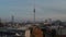 Forwards reveal of 20th century architecture in centre of town with dominant tall TV tower, Fernsehturm. Berlin, Germany