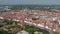 Forwards reveal of medieval city centre. Aerial panoramic view of historic brick buildings. Luebeck, Schleswig-Holstein